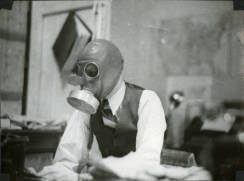 Shanke at his desk in a gas mask